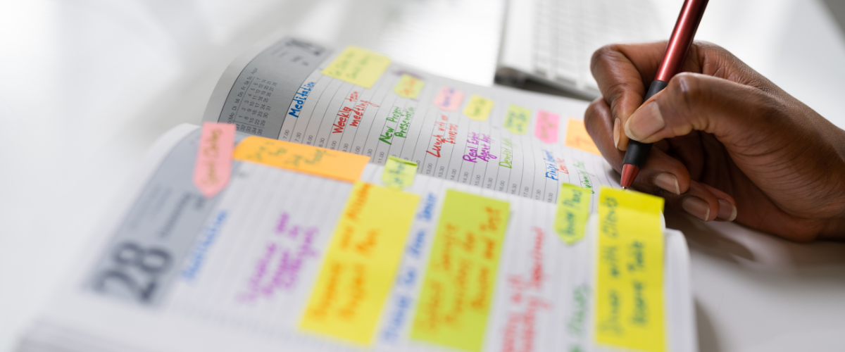 hand writing in an organizational planner